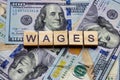 The word wages on dollar usa background. Finance and money concept. Royalty Free Stock Photo