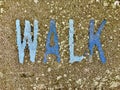 The word WALK on the floor in a kids park