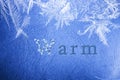 Word warm written on winter snowy blue background.