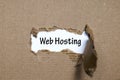 The word web hosting appearing behind torn paper Royalty Free Stock Photo