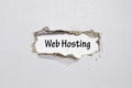 The word web hosting appearing behind torn paper Royalty Free Stock Photo