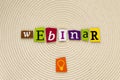 Word webinar made of magazine letters on bright background. Inscription webinar from multicolored letters showing concept of educa