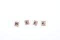 Word week arranged from wooden blocks on white background. Game