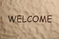 Word WELCOME and dry beach sand, top view Royalty Free Stock Photo