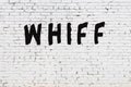 Word whiff painted on white brick wall