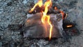 Word Wholesaler on a white sheet of paper burns into a fire against. Slow motion