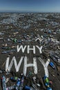 Word WHY spelled out amidst a littered shore, questioning pollution. Royalty Free Stock Photo