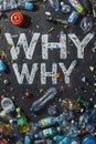 The word WHY surrounded by assorted garbage on dark surface. Royalty Free Stock Photo