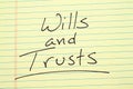 Wills and trusts on a yellow legal pad