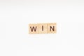 The word WIN is made of wooden cubes on a white background Royalty Free Stock Photo