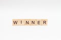 The word WINNER is made of wooden cubes on a white background. Winner concept Royalty Free Stock Photo