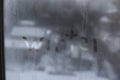 Word Winter drawn with a finger on glass condensation window against the blurred snow-covered city background. Royalty Free Stock Photo