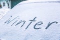 Word winter on the frozen glass of a car windshield. Car winter season concept Royalty Free Stock Photo