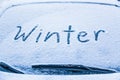 Word winter on the frozen glass of a car windshield. Car winter season concept Royalty Free Stock Photo