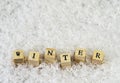 The word winter made of letters on wooden cubes on a snow background 2