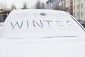 The word winter written on a car.