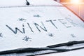 Word Winter written with finger on a snowy windshield of a car Royalty Free Stock Photo