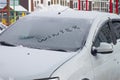 The word WINTER is written in the snow on the car window in winter Royalty Free Stock Photo