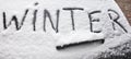 Word Winter written on snowy rear screen car Royalty Free Stock Photo