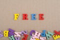 FREE word on wooden background composed from colorful abc alphabet block wooden letters, copy space for ad text. Learning english