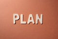 Word from wooden letters plan on a paper orange surface Royalty Free Stock Photo