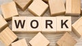 Word work with black letters on toy wooden cubes on table