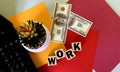 Word Work on wooden cubes .Next to a laptop a flower money on a multi-colored background.