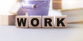 The word WORK is written in wooden cubes letters on white background Royalty Free Stock Photo