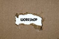 The word workshop appearing behind torn paper Royalty Free Stock Photo
