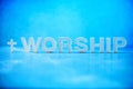 Word Worship made with cement letters on blue marble background. Copy space. Biblical, spiritual or christian reminder