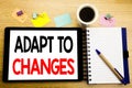 Word, writing Adapt To Changes. Business concept for Adaptation New Future Written on tablet laptop, wooden background with sticky