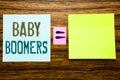 Word, writing Baby Boomers. Business concept for Demographic Generation written on sticky note paper on wooden background. Equatio Royalty Free Stock Photo