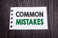 Word, writing Common Mistakes. Business concept for Common Concept written on sticky note paper on the dark wooden background. Bla Royalty Free Stock Photo