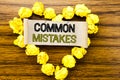 Word, writing Common Mistakes. Business concept for Common Concept written on sticky note paper on the dark wooden background. Wit Royalty Free Stock Photo