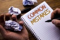 Word, writing Common Mistakes. Concept for Common Concept written on notebook notepad note paper on the wooden background with fol Royalty Free Stock Photo