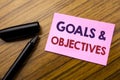 Word, writing Goals Objectives. Business concept for Plan Success Vision Written on sticky note red paper, wooden background with