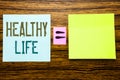 Word, writing Healthy Life. Business concept for Good Health Food written on sticky note paper on wooden background. Equation math Royalty Free Stock Photo