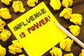 Word, writing Influence Is Power. Business concept for Persuasion Strategy Written on sticky note paper, wooden background with fo