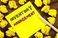 Word, writing Inventory Management. Business concept for Stock Supply Written on sticky note paper, wooden background with folded