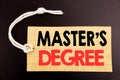 Word, writing Master s Degree. Business concept for online sale Academic Education written on price tag paper on the black vintage Royalty Free Stock Photo