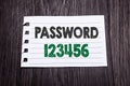 Word, writing Password 123456. Business concept for Security Internet written on sticky note paper on the dark wooden background. Royalty Free Stock Photo