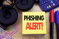Word, writing Phishing Alert. Business concept for Fraud Warning Danger written on sticky note paper on the wooden background. Wit Royalty Free Stock Photo