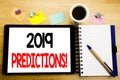 Word, writing 2019 Predictions. Business concept for Forecast Predictive Written on tablet laptop, wooden background with sticky n Royalty Free Stock Photo