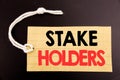 Word, writing Stake Holders. Business concept for online sale Stakeholder Engagement written on price tag paper on the black vinta Royalty Free Stock Photo