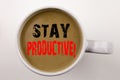 Word, writing Stay Productive text in coffee in cup Business concept for Concentration Efficiency Productivity on white background Royalty Free Stock Photo