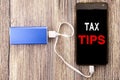 Word, writing Tax Tips. Business concept for Taxpayer Assistance Refund Reimbursement written on mobile cell phone mobile and powe Royalty Free Stock Photo