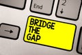 Word writing text Bridge The Gap. Business concept for Overcome the obstacles Challenge Courage Empowerment Keyboard yellow key In Royalty Free Stock Photo