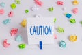 Word writing text Caution. Business concept for Care taken to avoid danger or mistakes Warning sign Prevention Colored crumpled Royalty Free Stock Photo