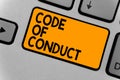 Word writing text Code Of Conduct. Business concept for Ethics rules moral codes ethical principles values respect Keyboard orange Royalty Free Stock Photo