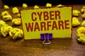 Word writing text Cyber Warfare. Business concept for Virtual War Hackers System Attacks Digital Thief Stalker Clip holding yellow